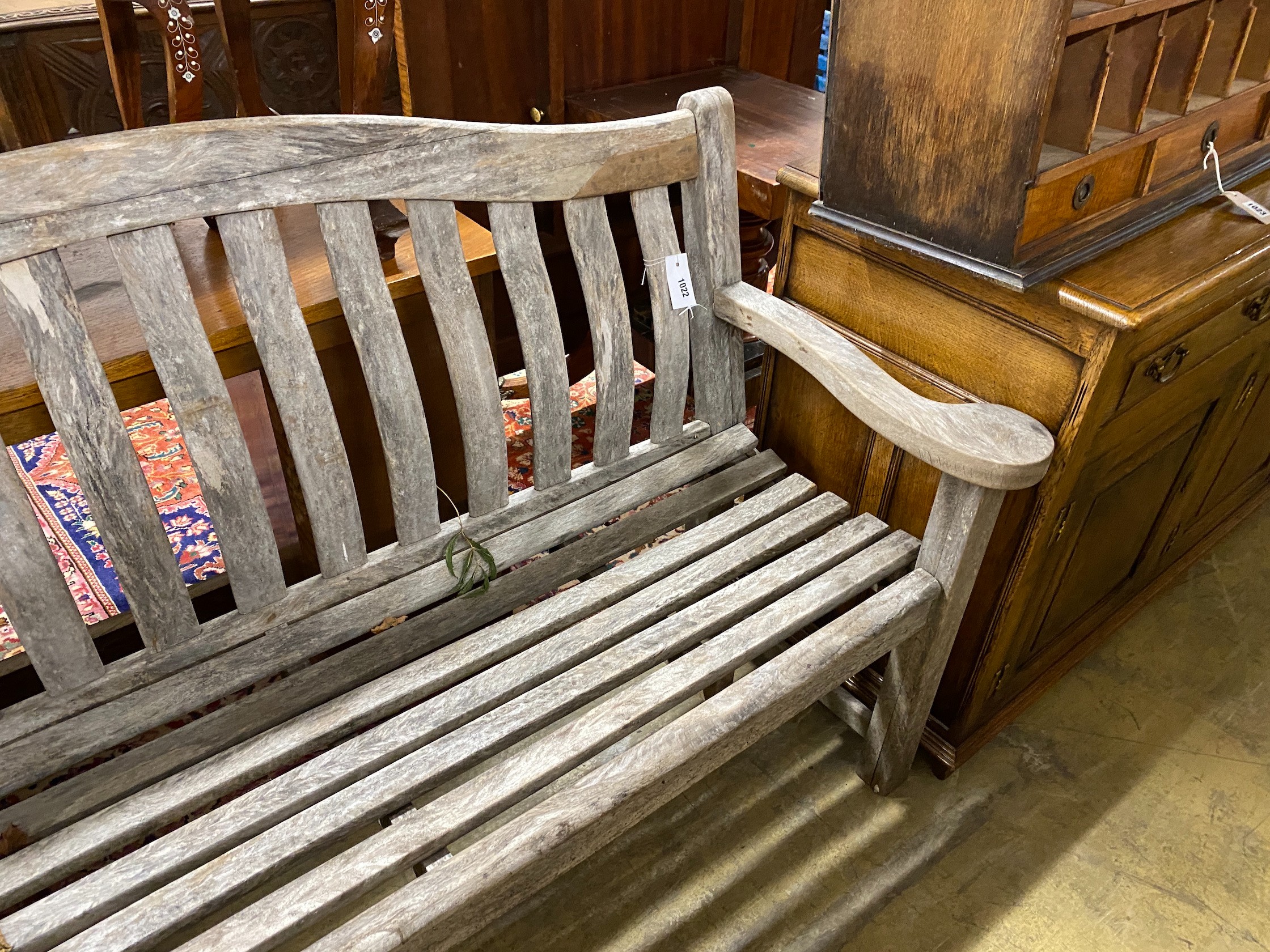 A pair of Alexander Rose weathered teak garden benches, length 155cm, depth 48cm, height 98cm
